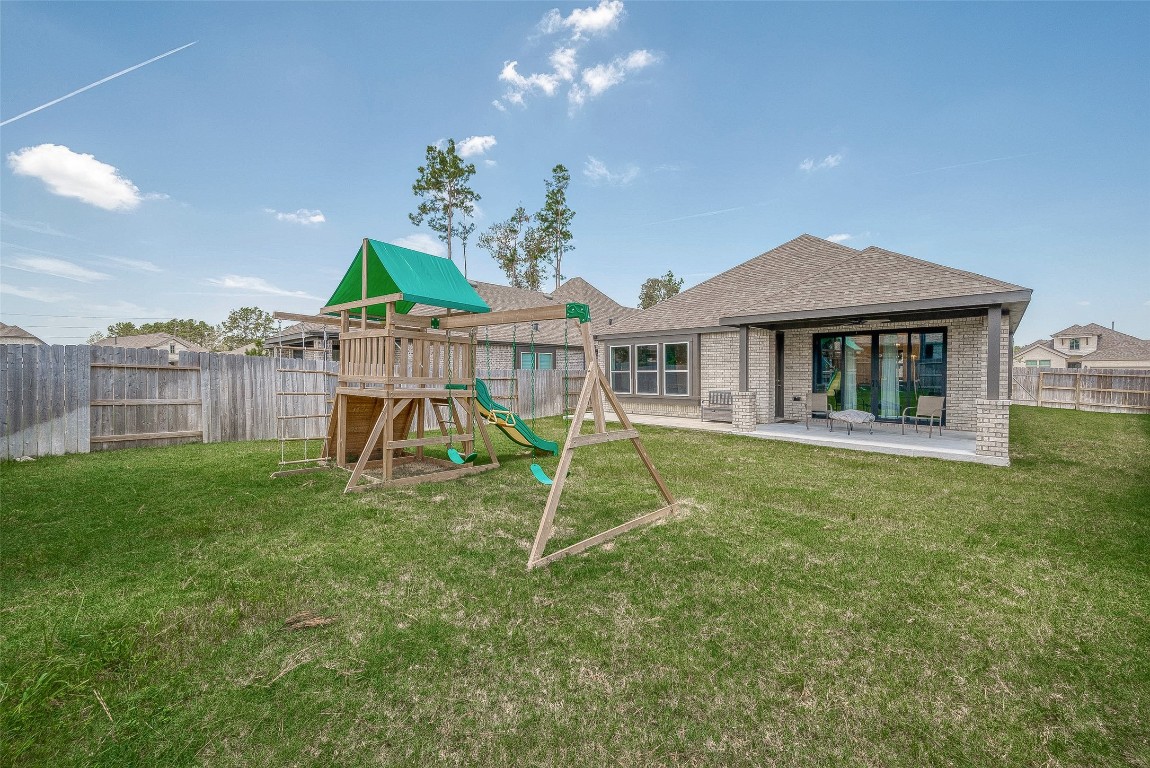 15714 Autumn Sun Conroe, TX 77302 - Photo 31 of 31 a house view with a garden space