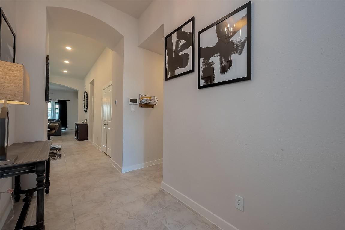 15714 Autumn Sun Conroe, TX 77302 - Photo 9 of 31 a view of a hallway with paintings on the wall