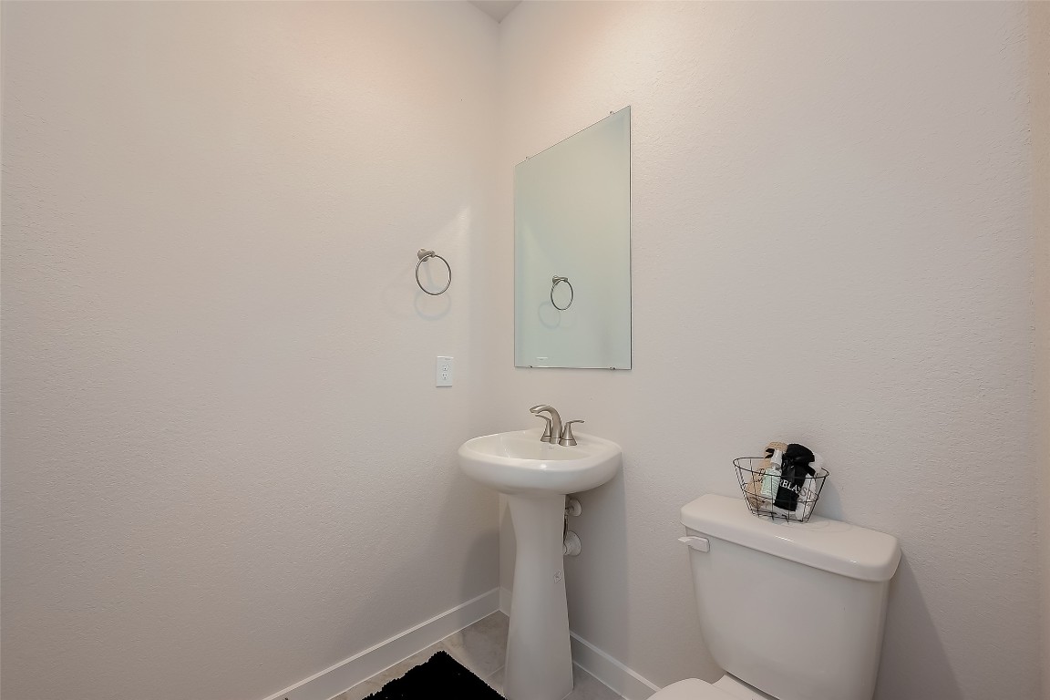 15714 Autumn Sun Conroe, TX 77302 - Photo 10 of 31 a bathroom with a sink a toilet and a mirror