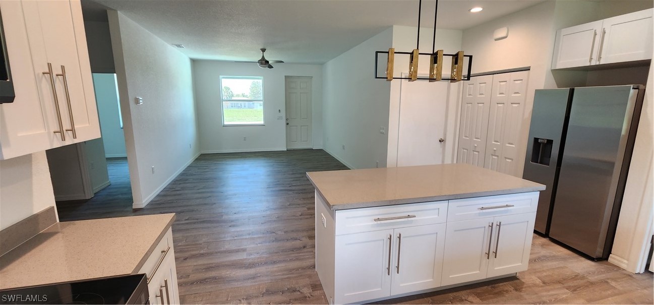 30036 Red Pine Road Punta Gorda, FL 33982 - Photo 8 of 12 a kitchen with white cabinets and refrigerator