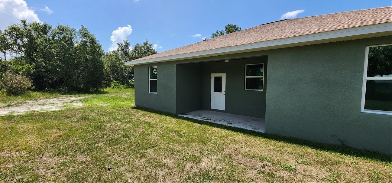 30036 Red Pine Road Punta Gorda, FL 33982 - Photo 10 of 12 a view of a house with a backyard