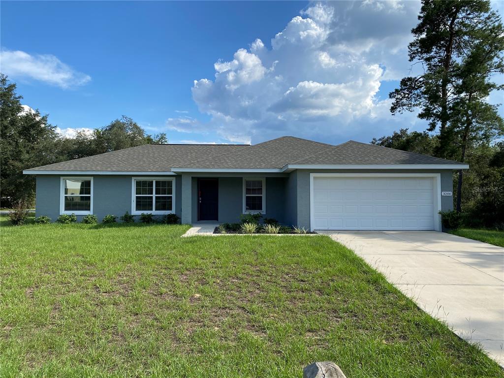 3200 Southwest 129th Loop Ocala, FL 34473 - Photo 1 of 29 a front view of a house with a garden and yard
