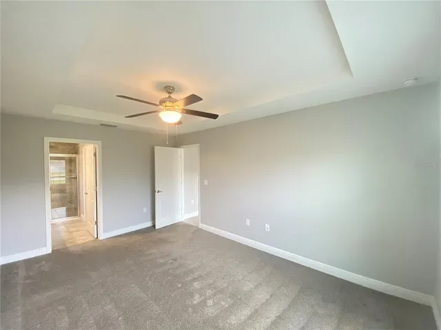 a view of a livingroom with a ceiling fan and window