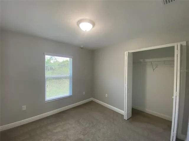 an empty room with closet and window