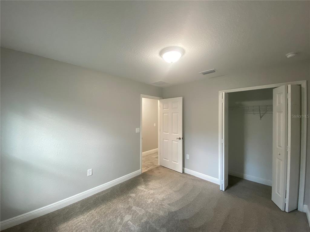 3200 Southwest 129th Loop Ocala, FL 34473 - Photo 24 of 29 an empty room with closet and windows