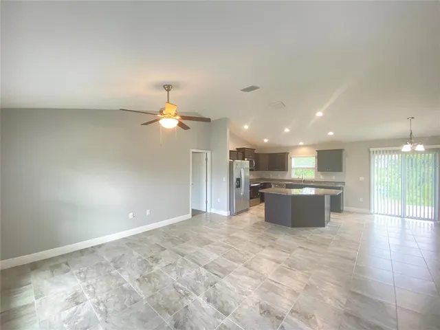 a view of a kitchen with a sink stainless steel appliances and cabinets