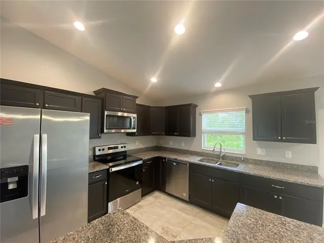 a kitchen with a sink and stainless steel appliances