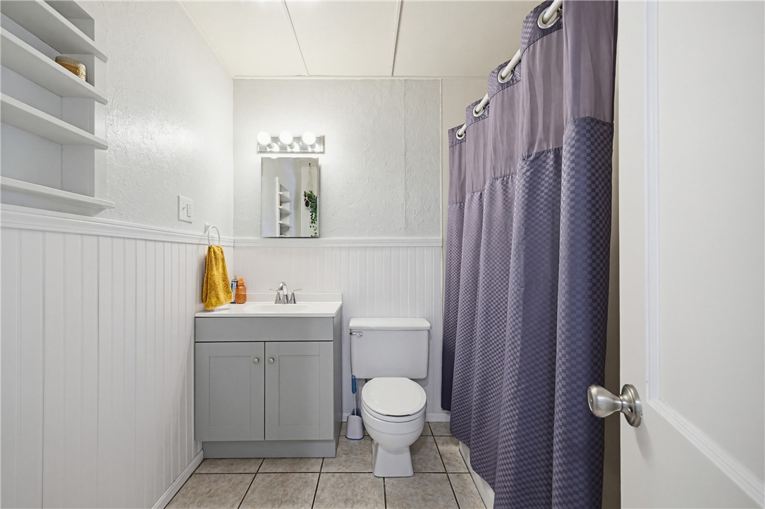 234 East Trant Road Kingsville, TX 78363 - Photo 16 of 32 a bathroom with a toilet a sink and mirror