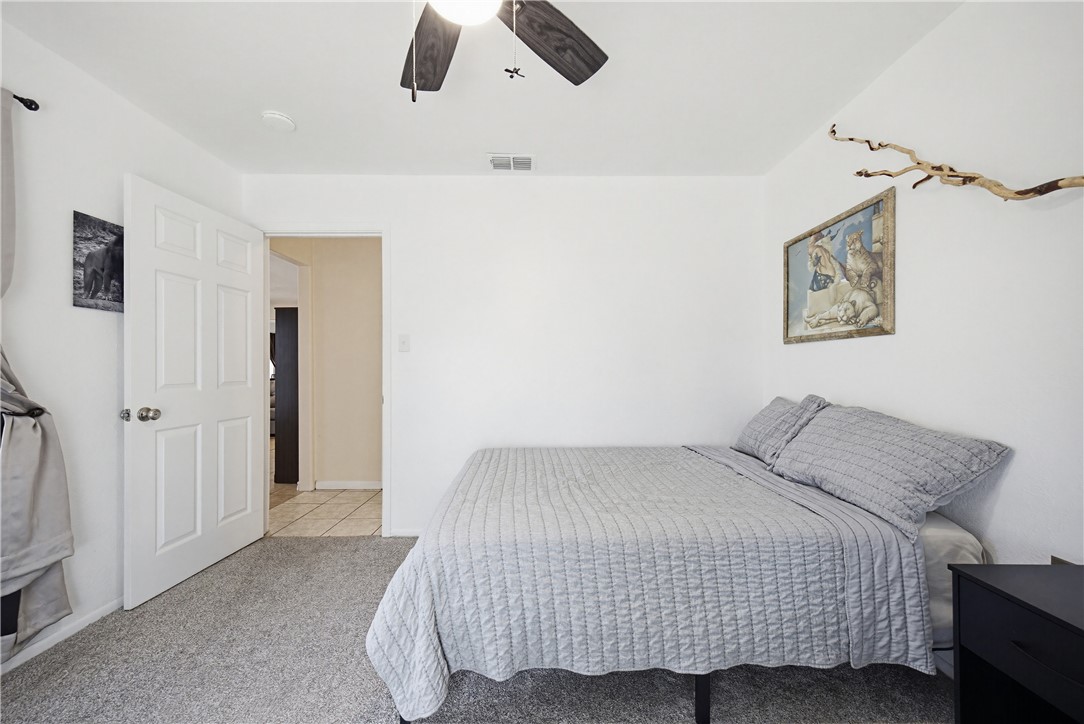 234 East Trant Road Kingsville, TX 78363 - Photo 21 of 32 a bedroom with a bed and painting on the wall