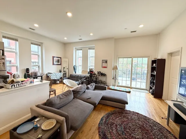 a living room with furniture window and a flat screen tv