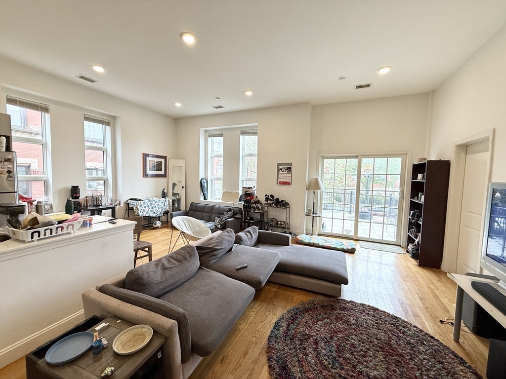 409 Dudley Street, Unit 2 Boston, MA 02119 - Photo 4 of 8 a living room with furniture window and a flat screen tv