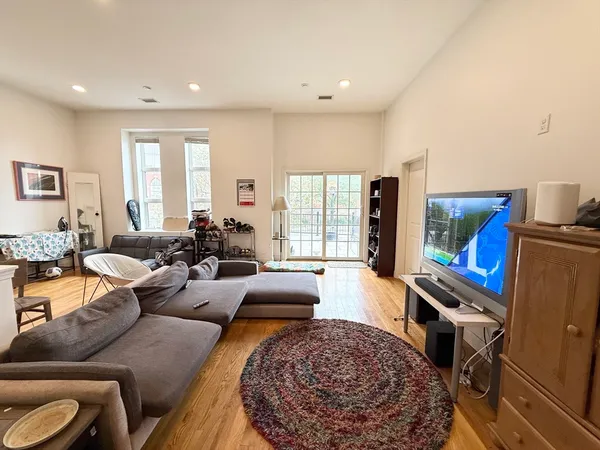 a living room with furniture and a rug