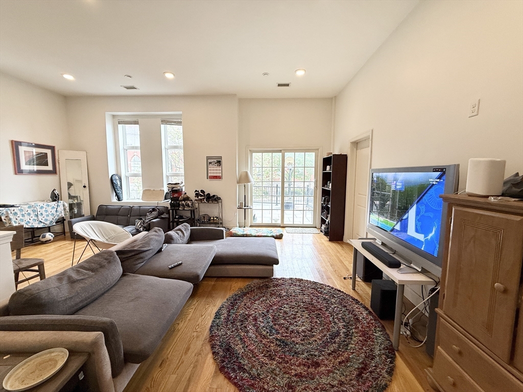409 Dudley Street, Unit 2 Boston, MA 02119 - Photo 5 of 8 a living room with furniture and a rug