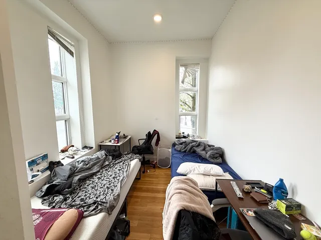 a bedroom with bed and a window