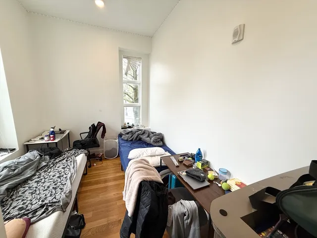 a bed room with two beds and a window