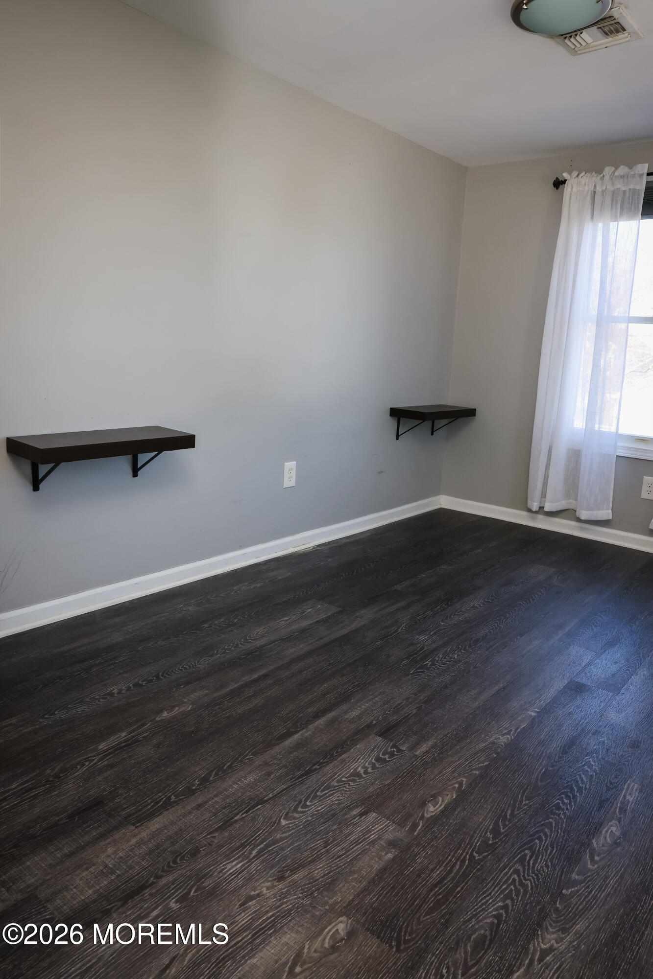 320 Lorillard Avenue Union Beach, NJ 07735 - Photo 11 of 24 an empty room with wooden floor and windows