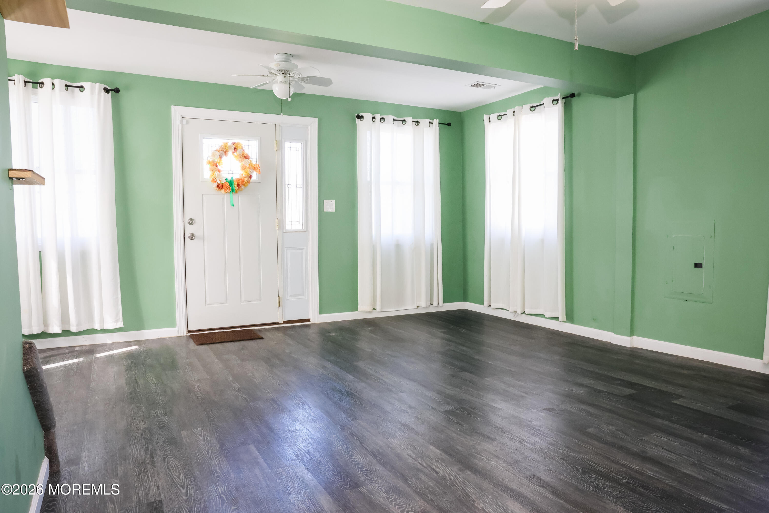 320 Lorillard Avenue Union Beach, NJ 07735 - Photo 4 of 24 a view of an empty room with window and wooden floor