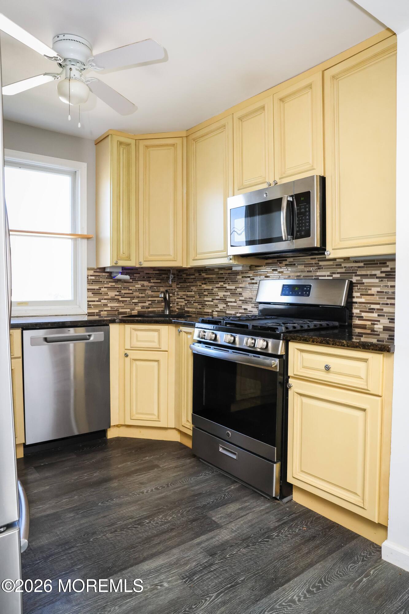 320 Lorillard Avenue Union Beach, NJ 07735 - Photo 5 of 24 a kitchen with stainless steel appliances granite countertop a stove a sink and a microwave