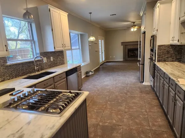 a kitchen with a stove a sink and a refrigerator