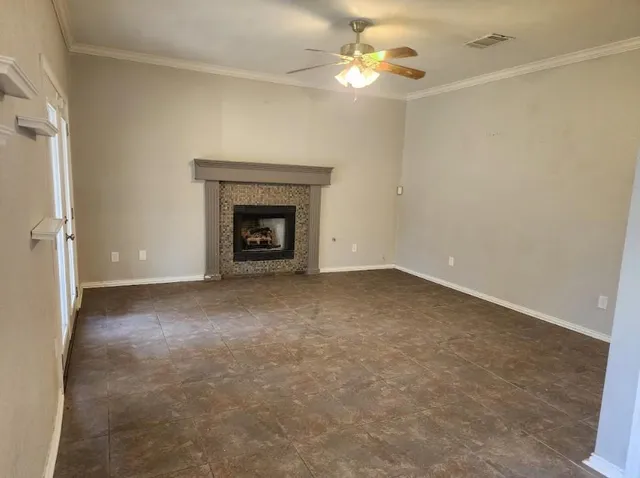an empty room with a fireplace and fan
