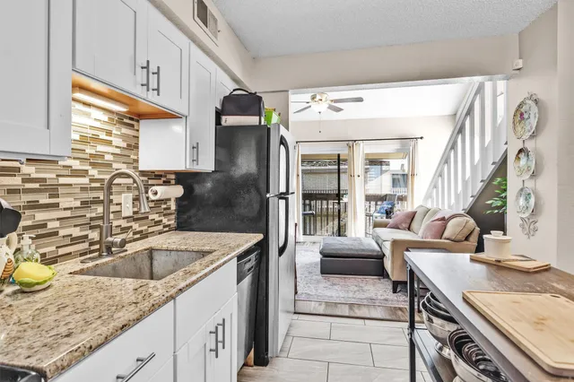 a kitchen with a sink stove and refrigerator