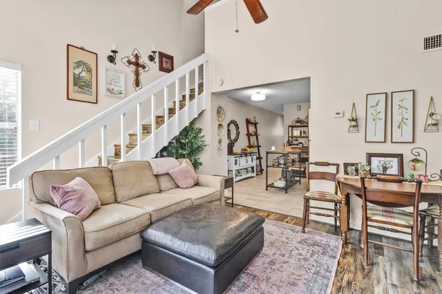 a living room with furniture and wooden floor