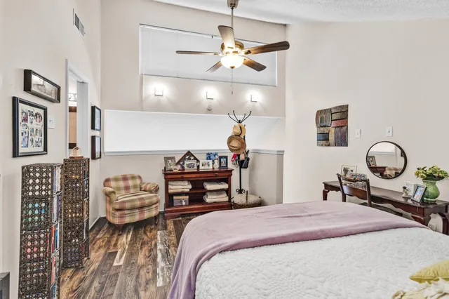 a bedroom with bed and a chandelier