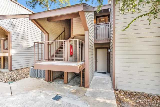 a view of a chair and table in the balcony