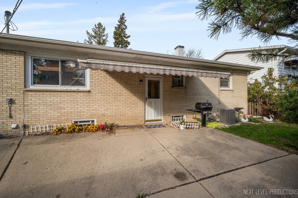 1417 Busse Road Mount Prospect, IL 60056 - Photo 20 of 22 a view of the house with a patio
