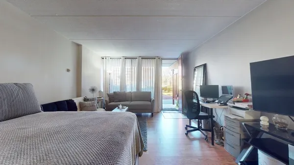 a room with furniture and next to a window
