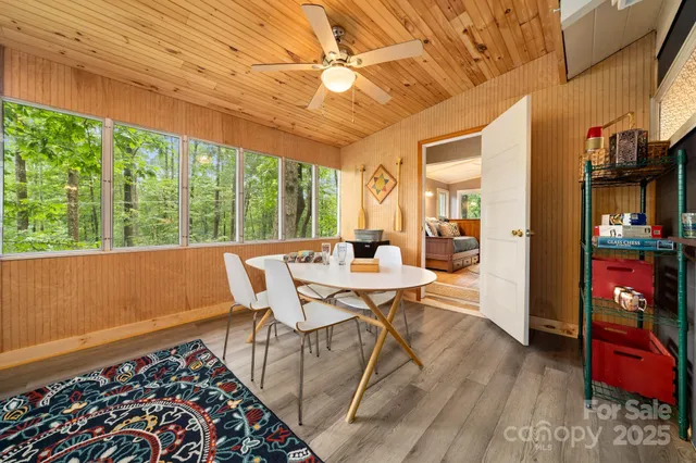 a view of a dining room with furniture a chandelier and wooden floor