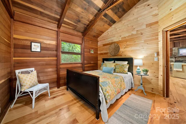 a bed sitting in a bedroom next to a brick building