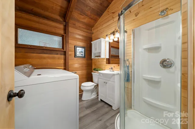 a bathroom with a granite countertop sink a toilet and shower