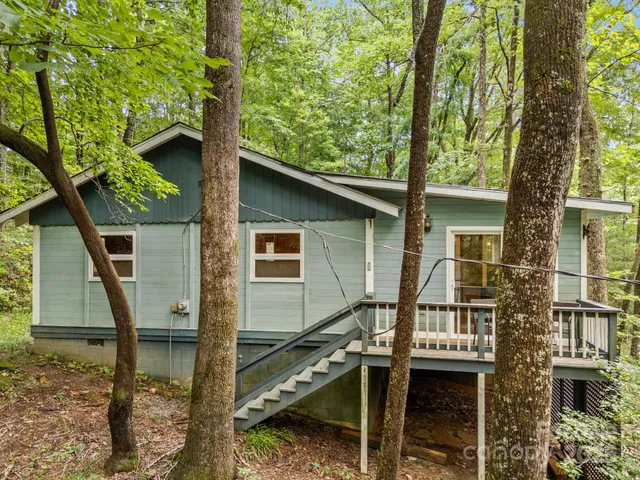 a view of a house with a window and wooden fence