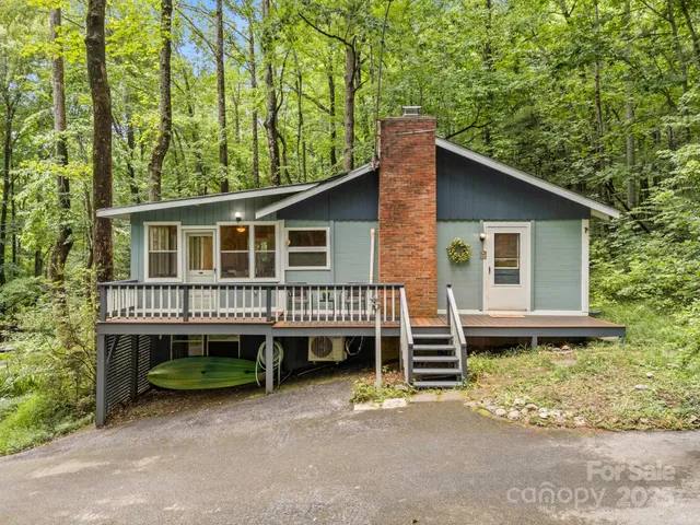 a view of a house with a backyard and deck