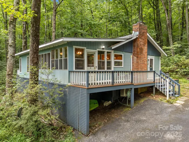 a view of a house with a yard and deck
