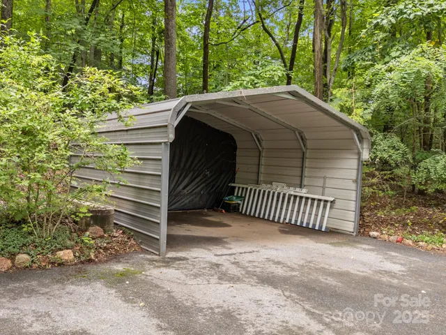 a view of a wooden house with a yard and stairs