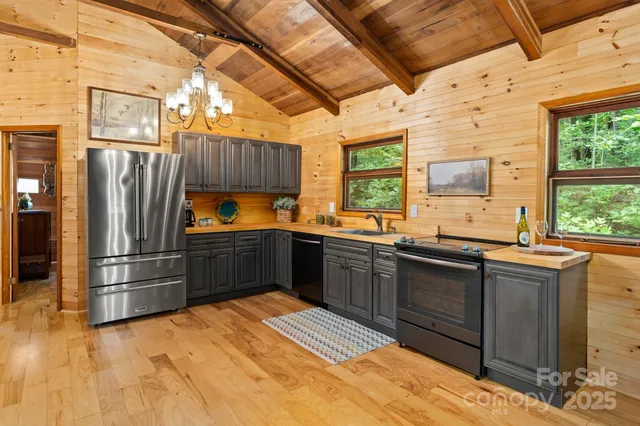 a kitchen with stainless steel appliances granite countertop a refrigerator and a sink