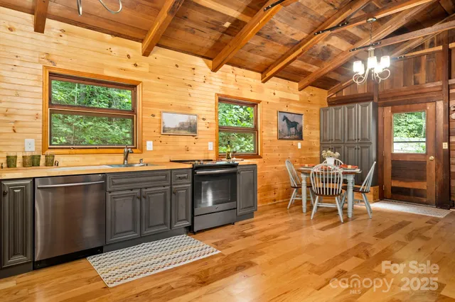 a large kitchen with a table and chairs