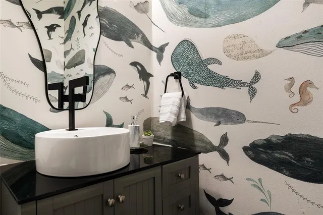 a bedroom with a bed and painting on the wall