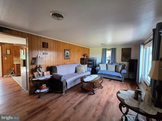a view of hallway with stainless steel appliances wooden floor