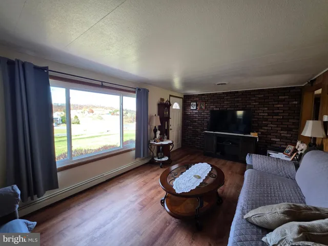a bedroom with furniture and a wooden floor