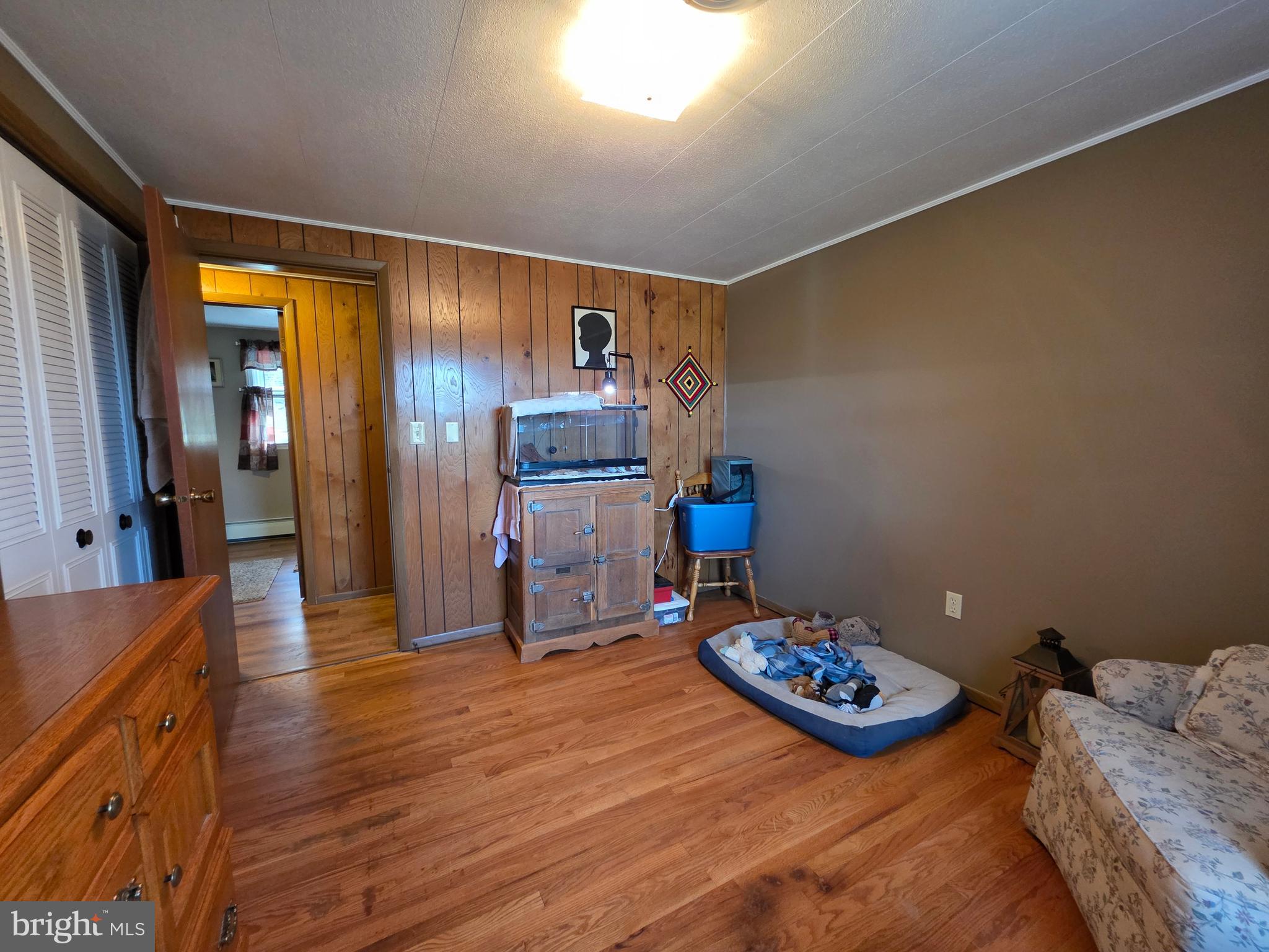 951 Johnsons Mill Road Berkeley Springs, WV 25411 - Photo 19 of 66 a bedroom with furniture and a wooden floor