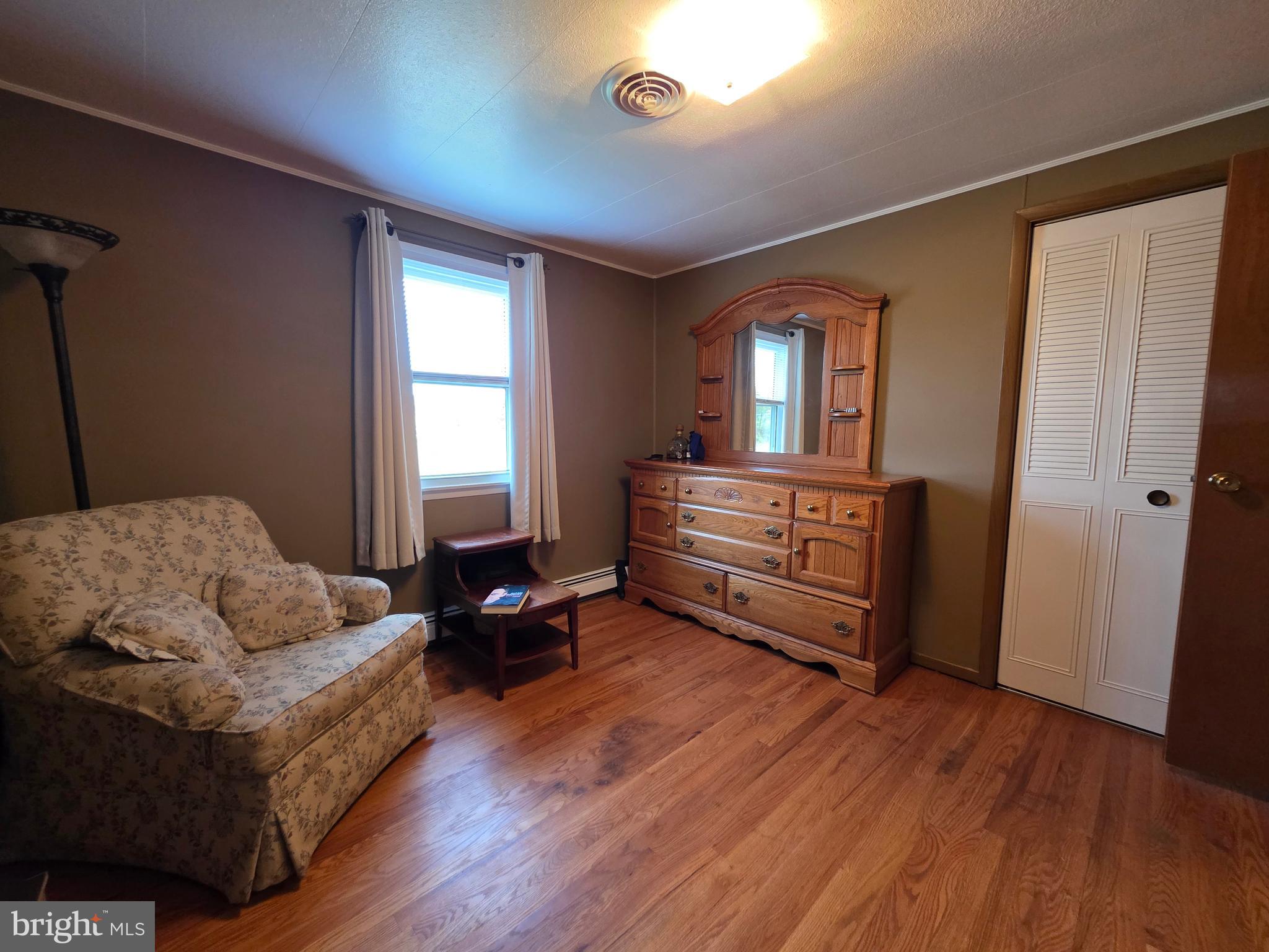 951 Johnsons Mill Road Berkeley Springs, WV 25411 - Photo 21 of 66 a living room with furniture and wooden floor