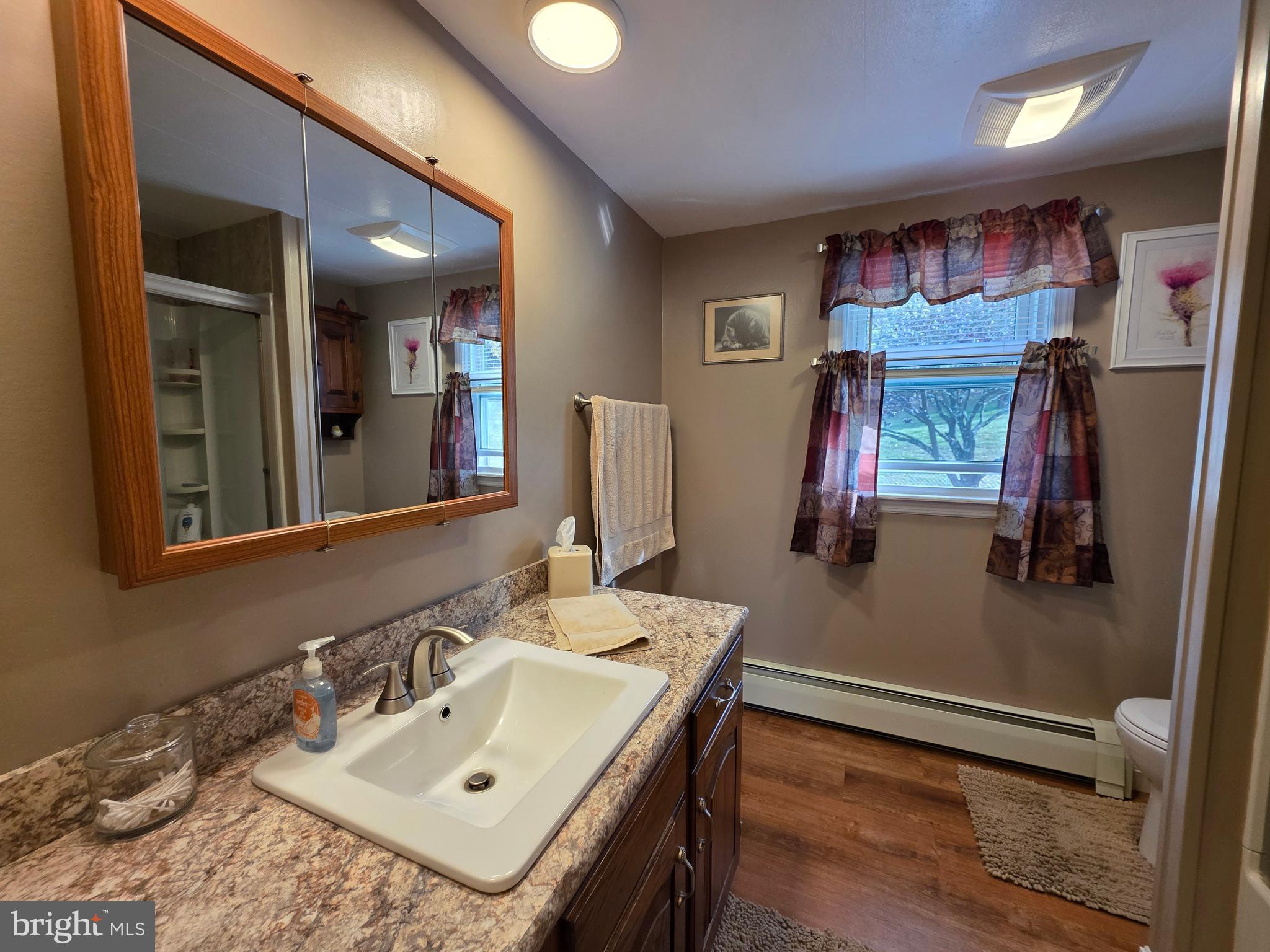 951 Johnsons Mill Road Berkeley Springs, WV 25411 - Photo 22 of 66 a bathroom with a sink vanity and mirror