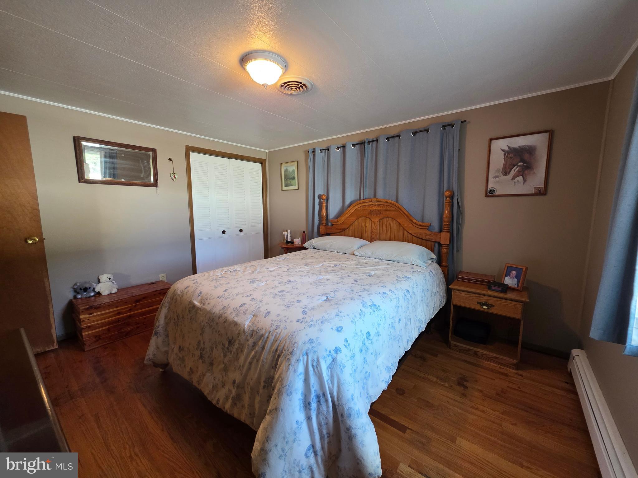 951 Johnsons Mill Road Berkeley Springs, WV 25411 - Photo 27 of 66 a bed sitting in a bedroom next to a window