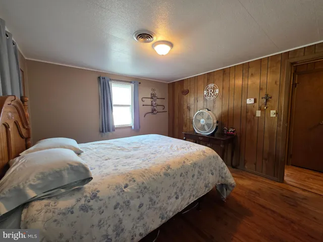 a bedroom with two beds and a window