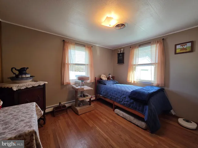 a living room with furniture a flat screen tv and gym equipment