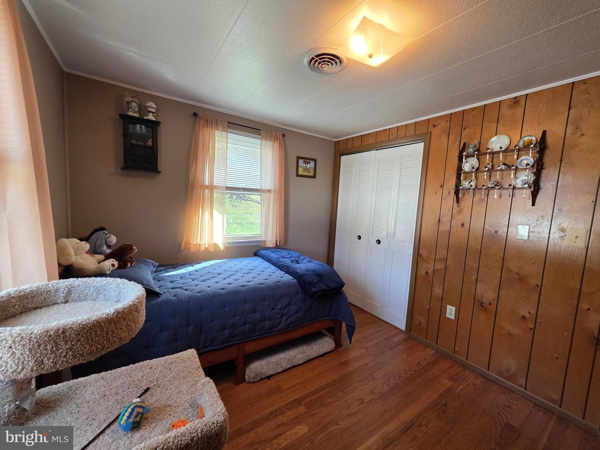 951 Johnsons Mill Road Berkeley Springs, WV 25411 - Photo 32 of 66 a bedroom with two beds and a window