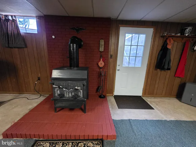 a house view with a sitting space fire pit and outdoor space